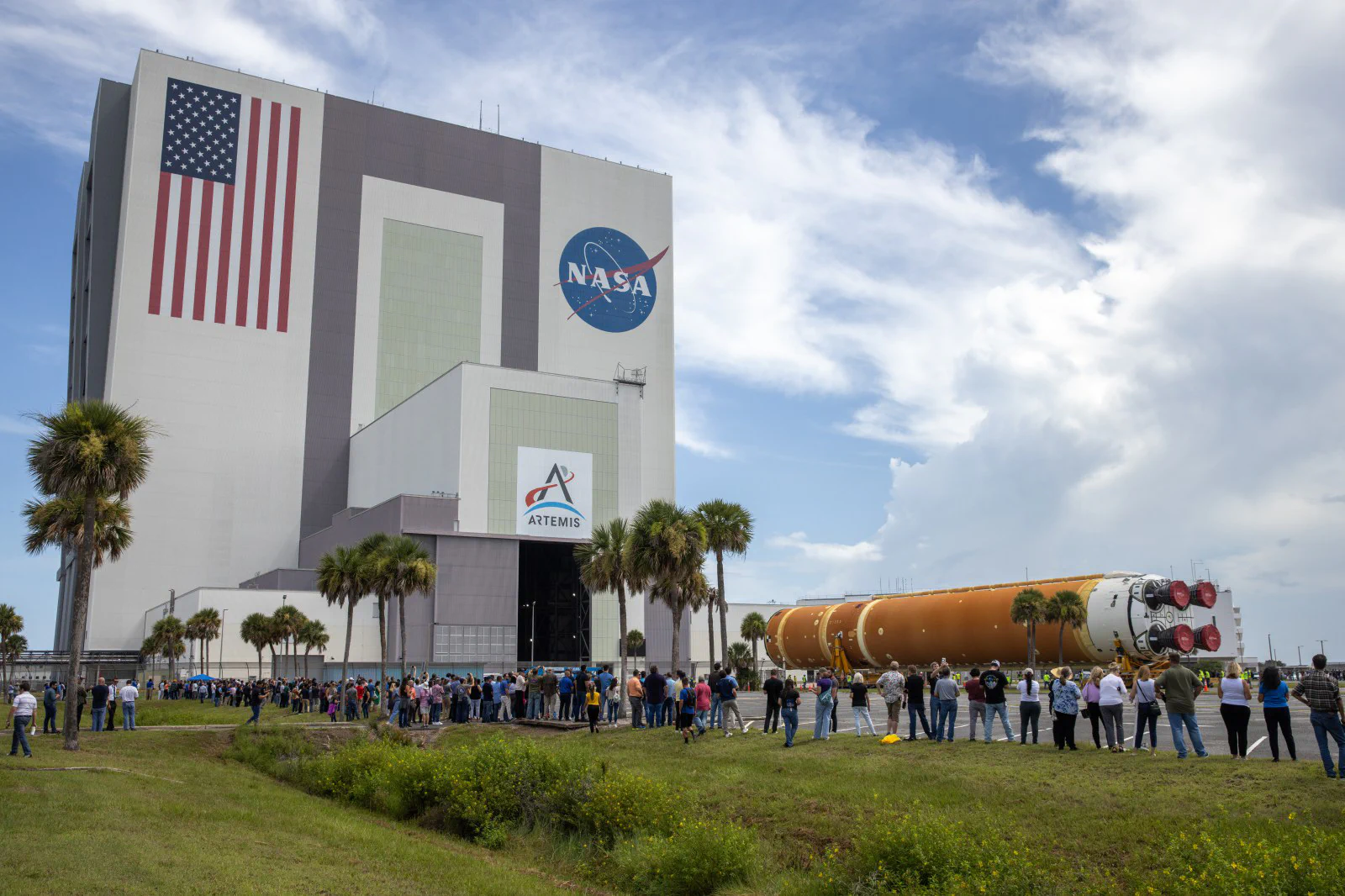 People gather as the Artemis II rocket core stage arrives at NASA’s Vehicle Assembly Building in July 2024.