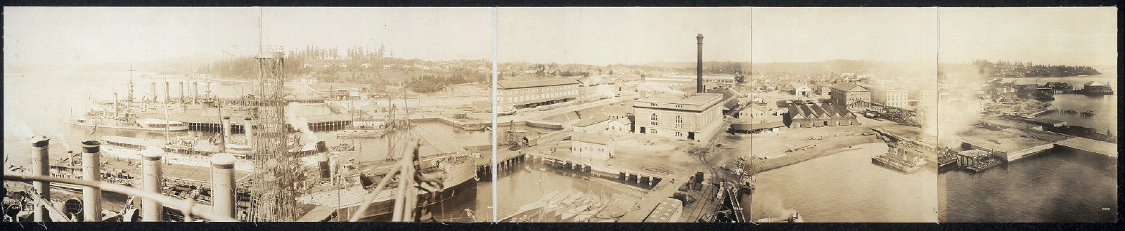 Panoramic view of ships and workshops at Bremerton Navy Yard in 1913.