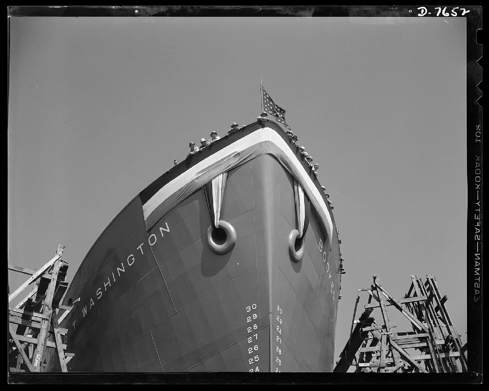Shipyard workers wave from the deck of the SS Booker T. Washington before its launch in California in 1942.